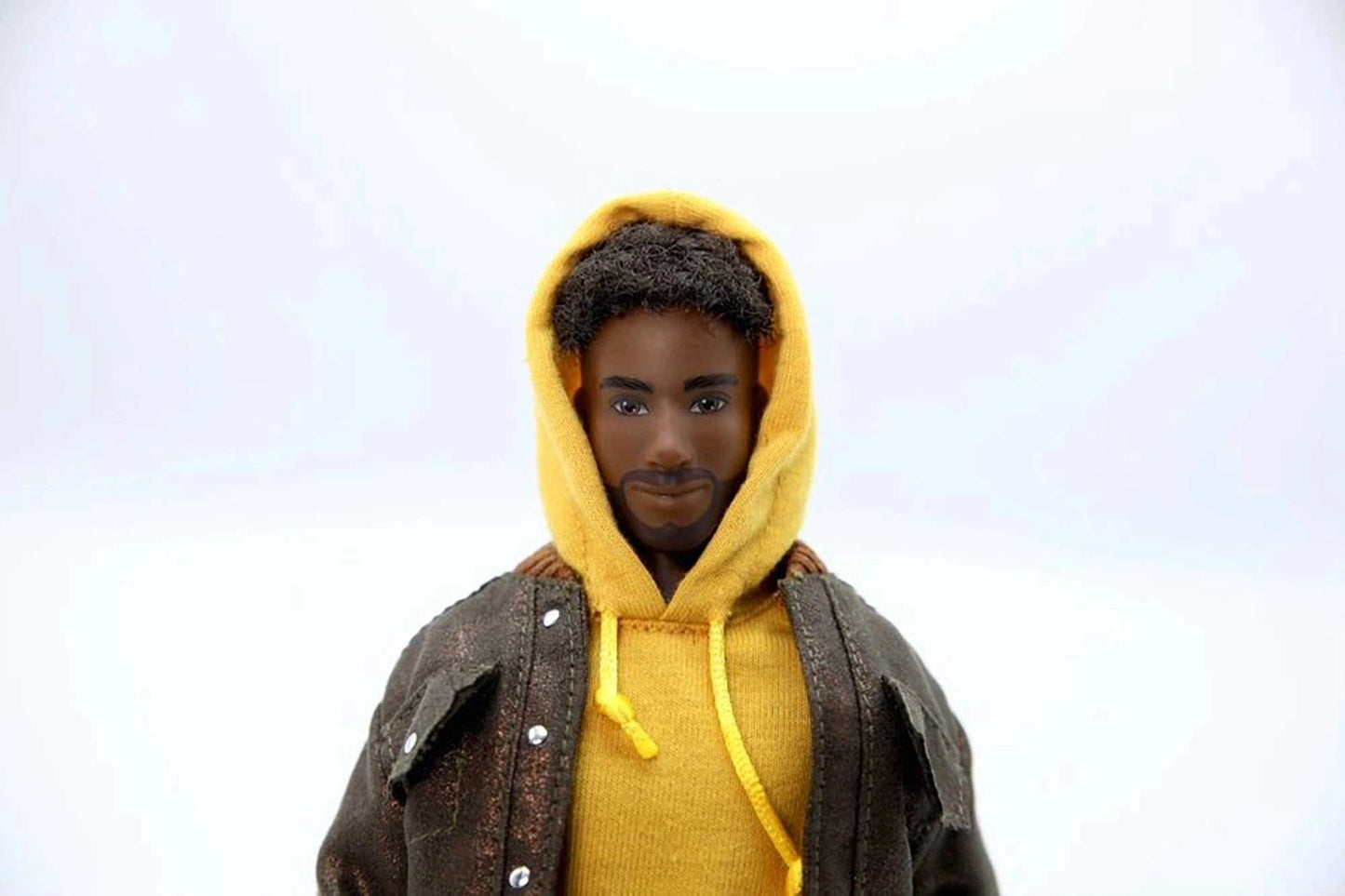 Person wearing a yellow hoodie with a gray jacket over it on a white background