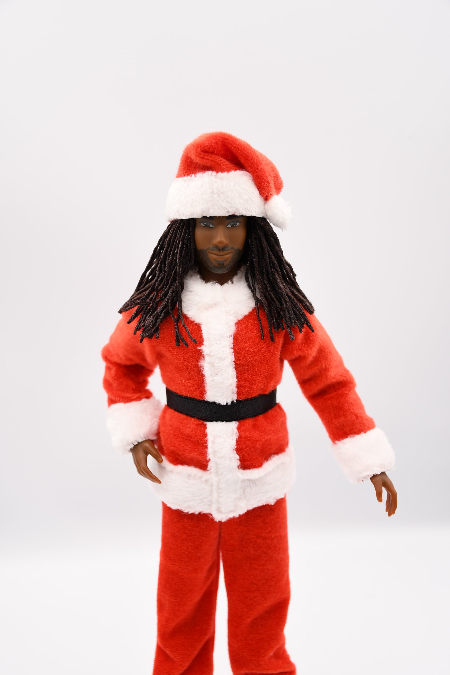 Doll wearing a red and white outfit with a black belt on a light gray background