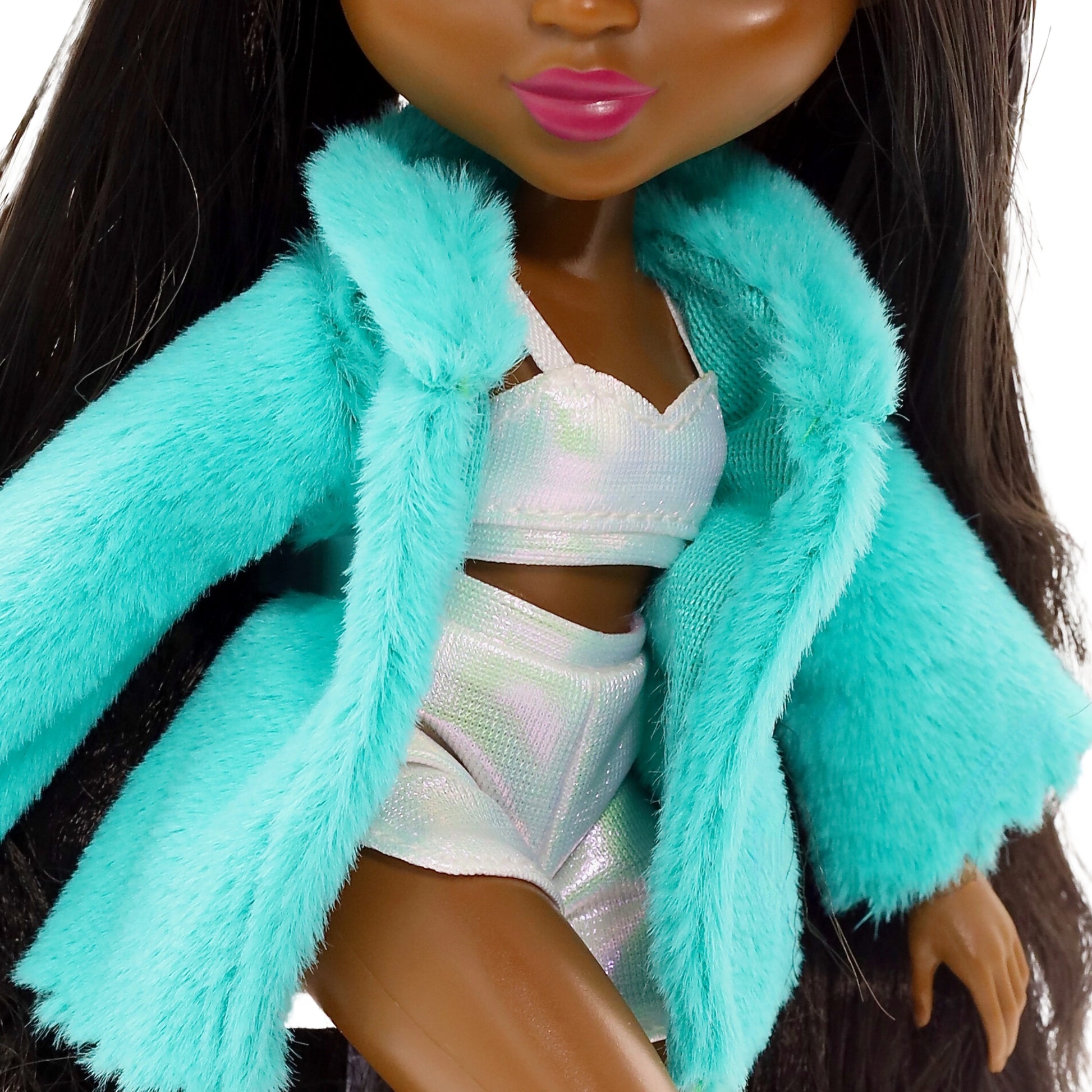 Doll wearing a turquoise fur coat over a white outfit with pink lipstick.