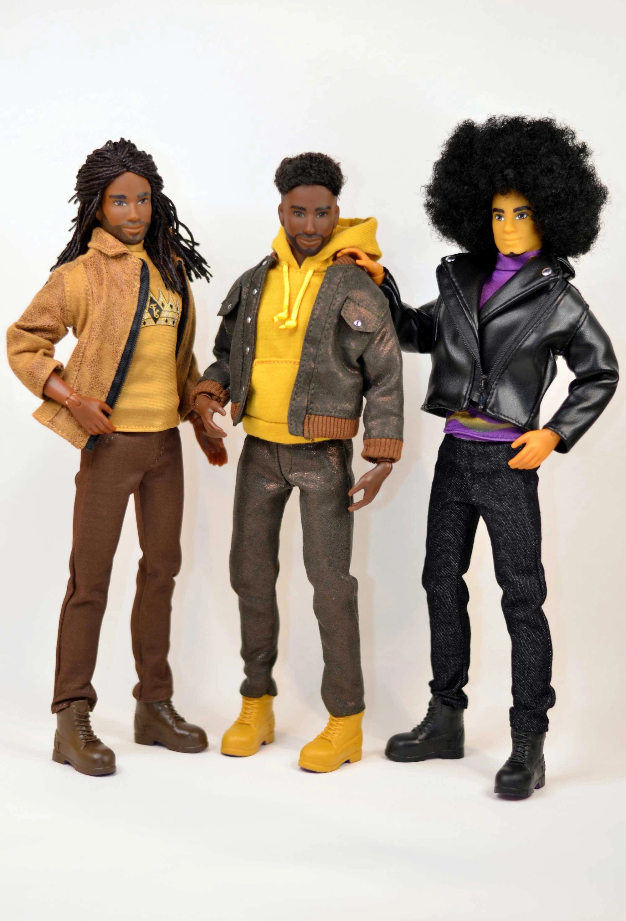 Three action figures with different hairstyles and outfits on a white background