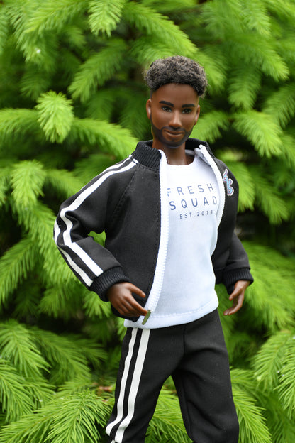 Mannequin wearing a black and white tracksuit with 'Fresh Squad' text against a green foliage background